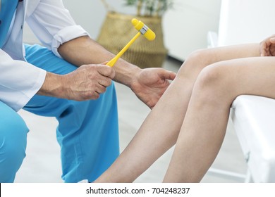 Doctor Examining The Knee Reflex