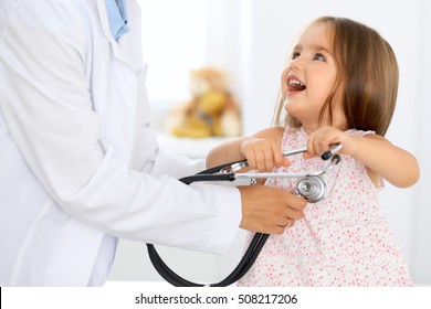 Doctor examining a little girl by stethoscope