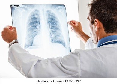 Doctor examining a lung radiography - Powered by Shutterstock