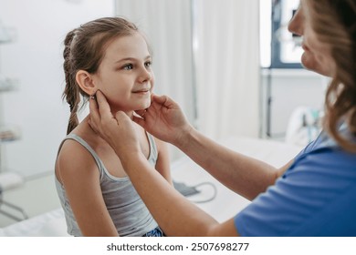 Doctor examining lymp nodes on neck of the young girl. Palpation of lymph nodes. Concept of school entry medical exam. - Powered by Shutterstock