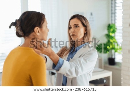 Doctor examining lymp nodes on neck of the teenage girl. Palpation of lymph nodes. Concept of preventive health care for adolescents.