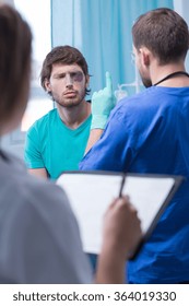 Doctor Examining Male Patient With Eye Injury