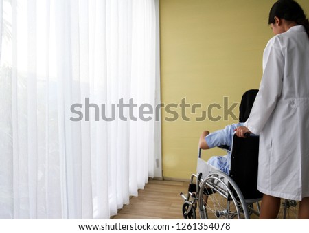 Similar – Senior woman in wheelchair alone in room