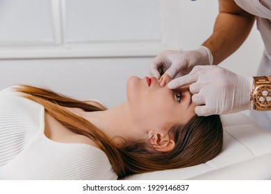 Doctor examining patient nose after rhinoplasty surgery, medical operation - Shutterstock ID 1929146837