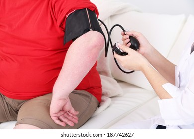 Doctor Examining  Patient Obesity On Light Background