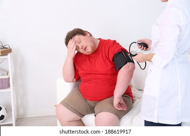 Doctor Examining  Patient Obesity On Light Background