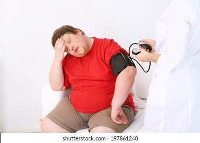 Doctor Examining  Patient Obesity On Light Background