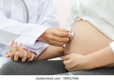 Doctor examining a pregnant woman - Powered by Shutterstock