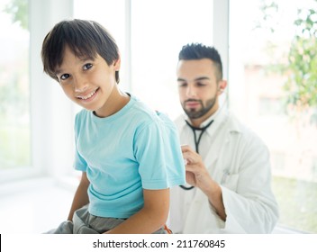 Doctor examining a school boy at hospital