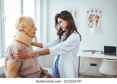 Doctor examining a senior female patient's x-ray, she is wearing a cervical collar and having a serious neck injury. Picture of adult woman having a visit at female doctor's office - Powered by Shutterstock