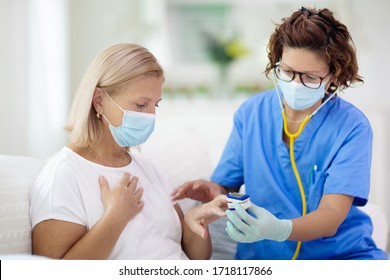 Doctor Examining Sick Patient In Face Mask. Ill Woman In Health Clinic For Test And Screening. Home Treatment Of Virus. Coronavirus Pandemic. Covid-19 Outbreak. Woman Coughing, Having Chest Pain.