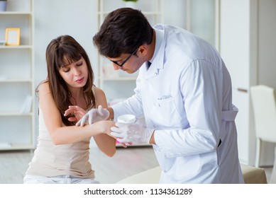 Doctor Examining The Skin Of Female Patient
