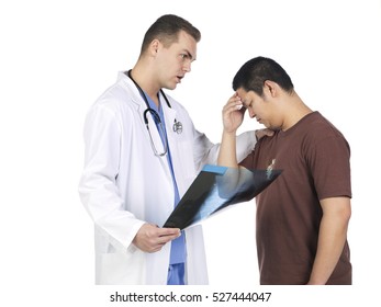 Doctor Examining X Rays And Giving The Patient Disturbing News About The Diagnosis