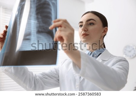 Doctor examining x-ray of lungs in hospital