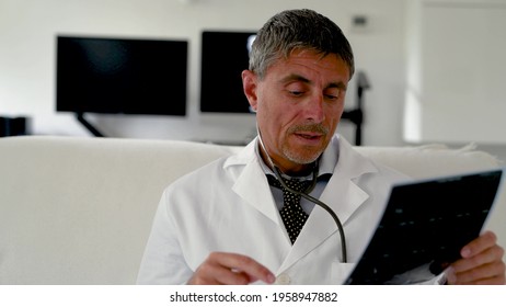 Doctor Examining X-ray Scan While Having Video Call During Isolation Quarantine. Medical Video Visit With Patient Using Web Platform. Healthcare And Medical Concept