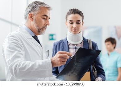 Doctor examining a young female patient's x-ray, she is wearing a cervical collar and having a serious neck injury - Powered by Shutterstock