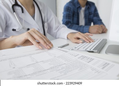 Doctor To Explain To The Patient While Checking Documents And Computer