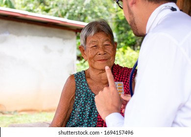 The Doctor Explained Medication To Elderly Patients Living In Rural Areas Of Asia,Community Health And Development Hospital In Remote Areas Development Fund Concept.