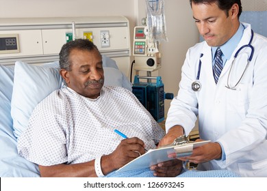 Doctor Explaining Consent Form To Senior Patient