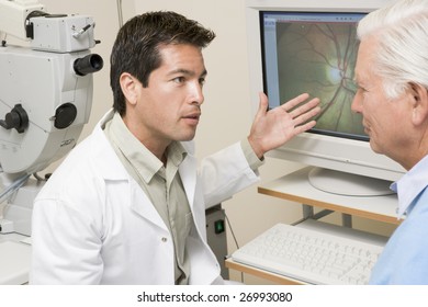 Doctor Explaining Eye Exam Results To Patient