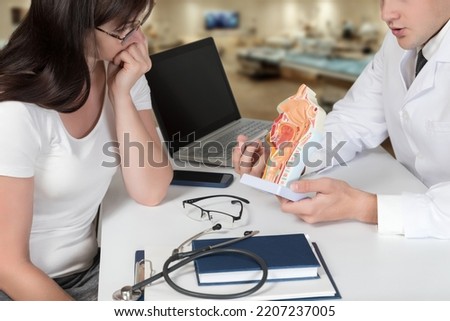Doctor explaining the features of the mucous membrane of a human patient in a hospital.