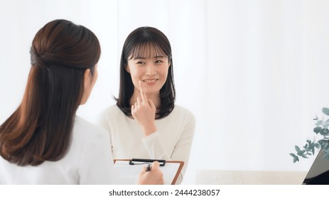 Doctor explaining to female patient undergoing examination. Interview at the hospital. - Powered by Shutterstock