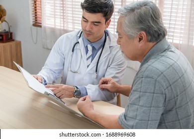 Doctor Explaining Health Examination Results With Elderly Patient At Home Visit