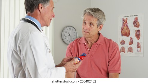 Doctor Explaining Heart To Elderly Patient