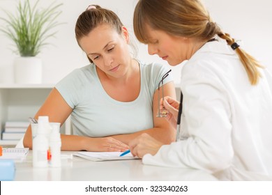 Doctor explaining to her patient about the treatment for her condition. - Powered by Shutterstock