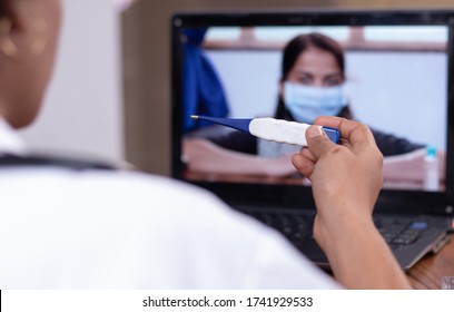 Doctor explaining how to use fever thermometer to patient through online on laptop - Concept of Online Chat, telehealth, or tele counseling with patient during coronavirus or covid-19 crisis.