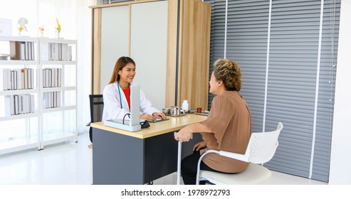 Doctor Explaining Medication To Old Woman Patient At Hospitals