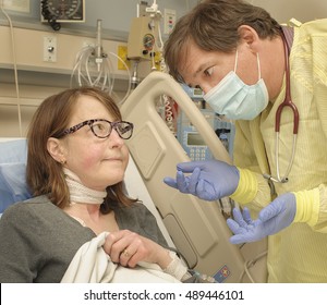 Doctor Explaining Options To Female Patient Recovering After Surgery In Post Operative Care Room In Modern Hospital.