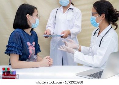 Doctor Explaining The Results Of The Examination To Young Asian Woman At A Temporary Medical Facility During The Covid 19 Epidemics At Field Hospital, Health Medical Checkup Concept.