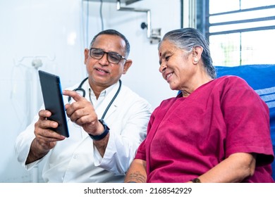 Doctor explaining from tab to senior pateint about health condition after surgery - concept of technology, health care and relaxation. - Shutterstock ID 2168542929