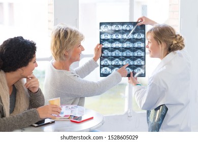 Doctor Explaining Xray To Female Patient