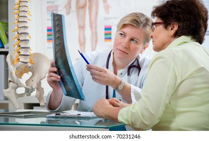 Doctor explaining x-ray results to patient - Powered by Shutterstock