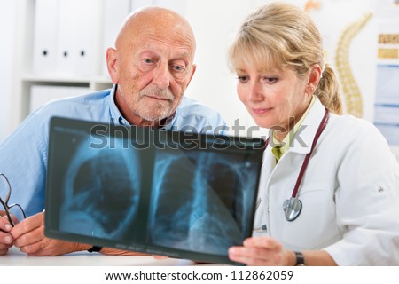Doctor explaining x-ray results to senior patient