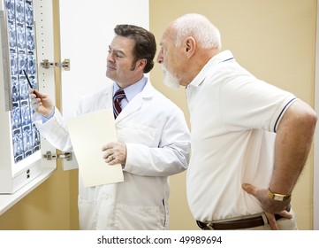Doctor Explains A CT Scan Of The Spine To His Senior Patient.