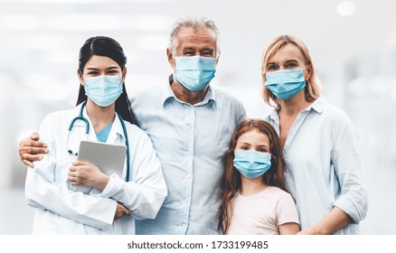 Doctor And Family Wear Face Mask In Hospital Protect From COVID-19. People Health Care And Medicine Concept.