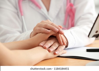 Doctor with female patient after chemotherapy in hospital, closeup