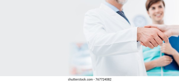 Doctor And Female Patient Meeting At The Hospital And Shaking Hands, Healthcare And Medicine Banner