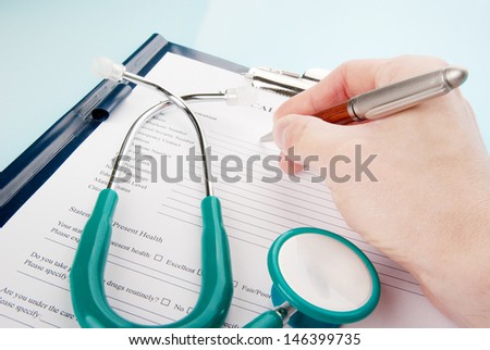 doctor filling medical questionnaire form stethoscope stock photo