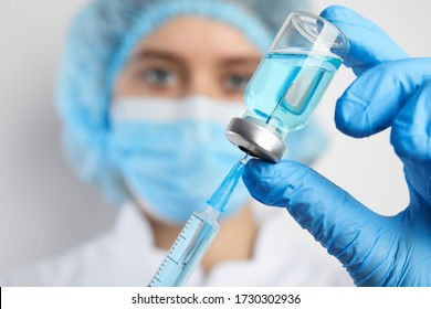 Doctor filling syringe with medication, closeup. Vaccination and immunization - Powered by Shutterstock