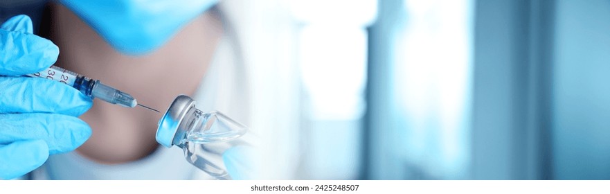 Doctor filling syringe with medication from glass vial on blurred background, closeup. Banner design - Powered by Shutterstock