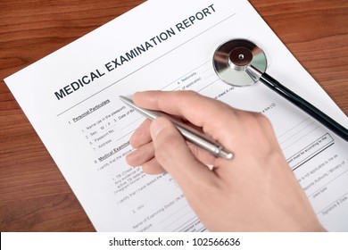 Doctor Fills Out Blank Medical Report Form.