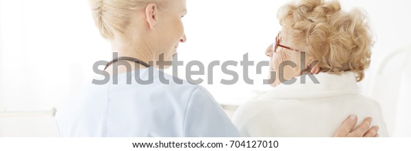 Doctor Gently Patting Her Senior Patient Stock Photo (Edit Now) 704127 image