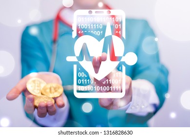 Doctor Gives Gold Coin And Uses Virtual Screen Touch Smartphone Heart Pulse Icon. Health Monitoring App Concept. Insurance Bitcoins Blockchain Healthcare Tech.