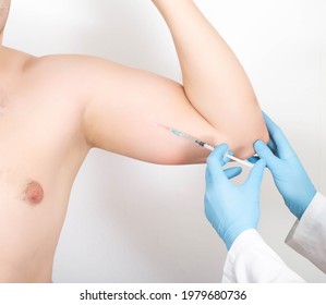 A Doctor Gives An Injection Into A Man's Forearm To Increase The Muscle Mass Of His Biceps. Muscle Strength Injection Drugs Concept