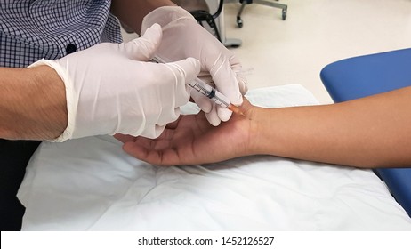 Doctor giving the anti-inflammatory drug injection to patient ‘s hand for treatment carpal tunnel syndrome(CTS) or median nerve compressive neuropathy disease. Medical and Physical therapy concept