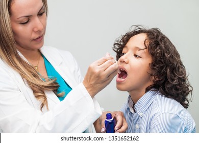 Doctor Giving A Child Homeopathic Medicine Or Vaccine